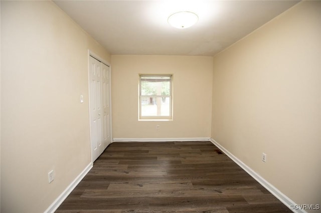 407 E 2nd St, Farmville, VA 23901 - unfurnished bedroom with dark wood-style flooring and a closet