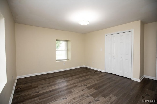 407 E 2nd St, Farmville, VA 23901 - unfurnished bedroom with dark wood finished floors and a closet
