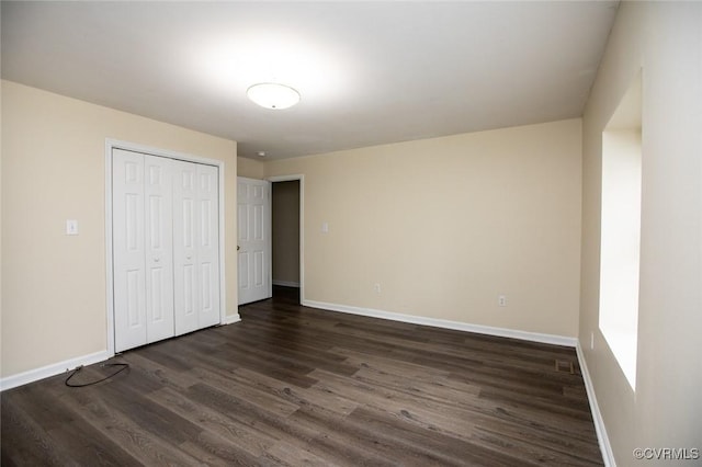 407 E 2nd St, Farmville, VA 23901 - unfurnished bedroom with dark wood-style floors and a closet