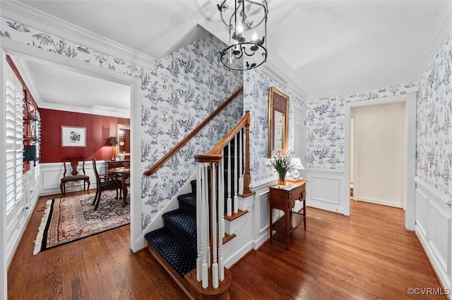 5911 Waters Edge Rd, Midlothian, VA 23112 - entryway featuring wallpapered walls, a chandelier, stairs, wood finished floors, and wainscoting