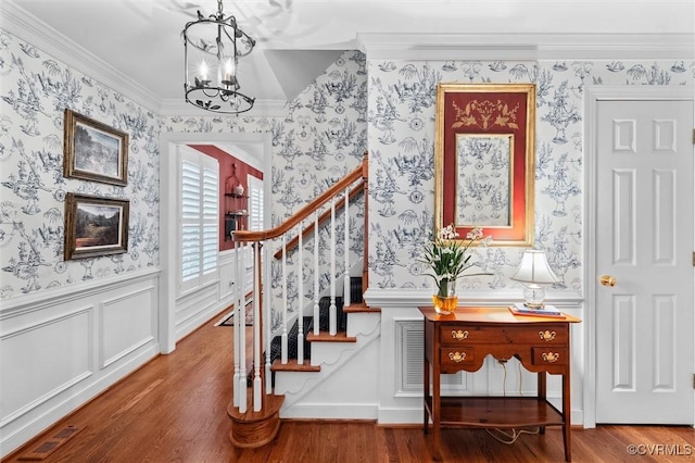 5911 Waters Edge Rd, Midlothian, VA 23112 - stairs featuring wallpapered walls, a chandelier, wainscoting, wood finished floors, and ornamental molding