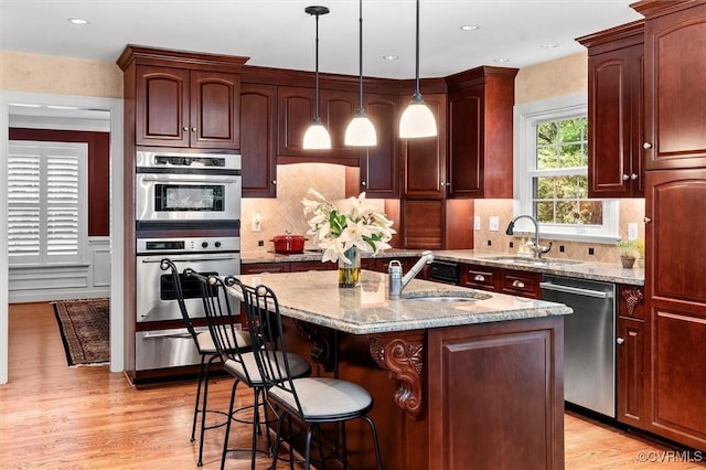 5911 Waters Edge Rd, Midlothian, VA 23112 - kitchen featuring stainless steel appliances, light wood-style floors, light stone countertops, and recessed lighting