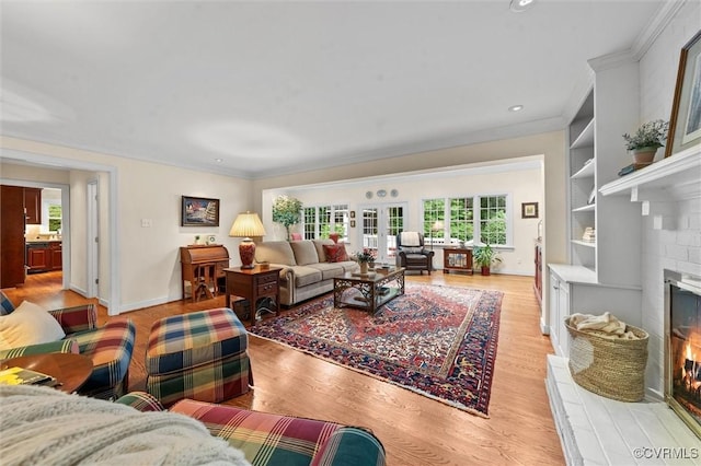 5911 Waters Edge Rd, Midlothian, VA 23112 - living room featuring healthy amount of natural light, a fireplace, ornamental molding, light wood-style floors, and recessed lighting