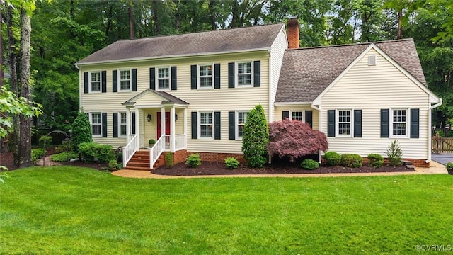 5911 Waters Edge Rd, Midlothian, VA 23112 - colonial home with a chimney, a front yard, and a shingled roof