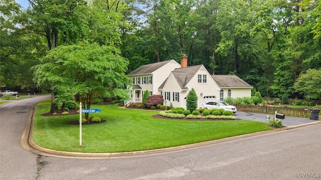 5911 Waters Edge Rd, Midlothian, VA 23112 - view of front facade with concrete driveway, a front yard, a chimney, and a garage