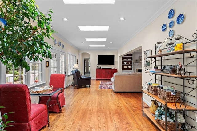 5911 Waters Edge Rd, Midlothian, VA 23112 - living area featuring wood finished floors, a skylight, ornamental molding, arched walkways, and recessed lighting