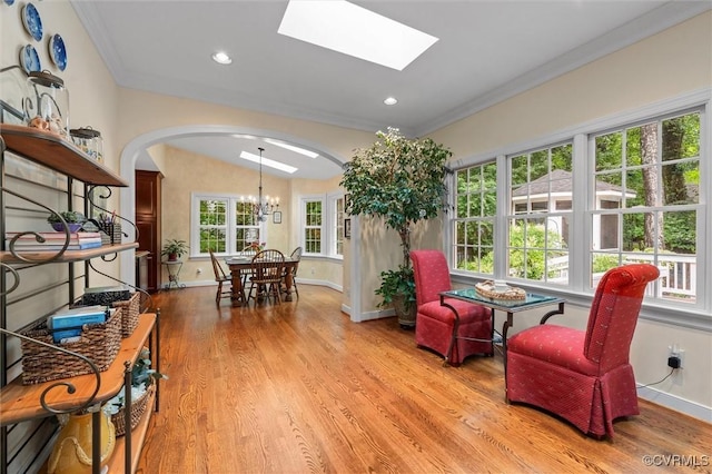 5911 Waters Edge Rd, Midlothian, VA 23112 - living area with arched walkways, crown molding, light wood-style floors, a chandelier, and recessed lighting