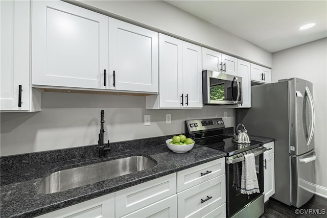 9312 Groundhog, Chesterfield, VA 23235 - kitchen with appliances with stainless steel finishes, white cabinetry, dark stone counters, dark wood-type flooring, and recessed lighting