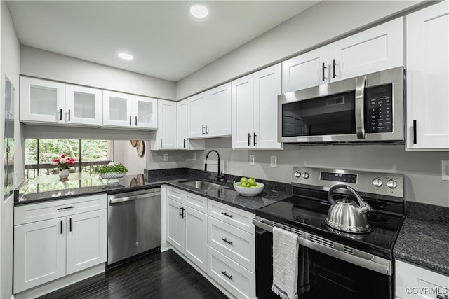 9312 Groundhog, Chesterfield, VA 23235 - kitchen with stainless steel appliances, recessed lighting, white cabinetry, glass insert cabinets, and dark stone counters