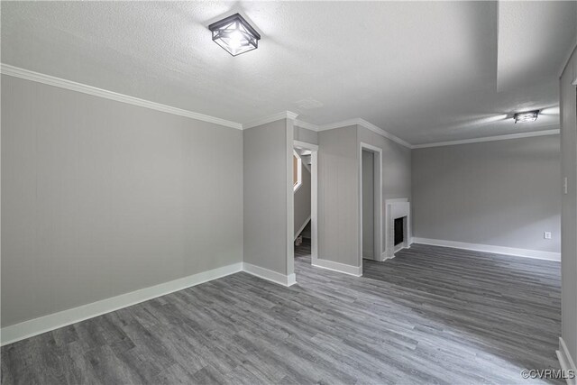 9312 Groundhog, Chesterfield, VA 23235 - unfurnished living room with dark wood-style flooring, ornamental molding, a textured ceiling, stairs, and a fireplace