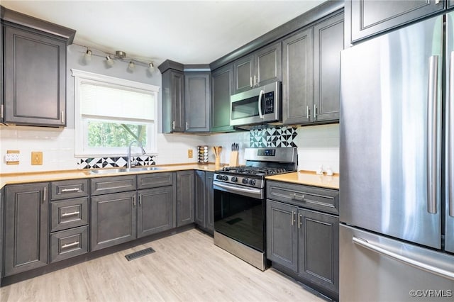 17009 Faithful Run, Montpelier, VA 23192 - kitchen featuring stainless steel appliances, light wood finished floors, light countertops, and tasteful backsplash