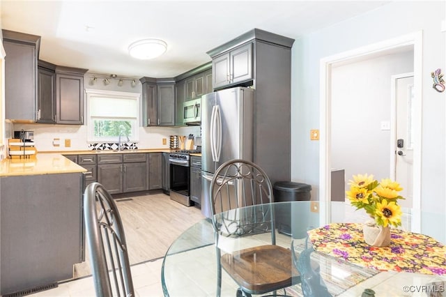 17009 Faithful Run, Montpelier, VA 23192 - kitchen with appliances with stainless steel finishes, light countertops, and light wood-style flooring
