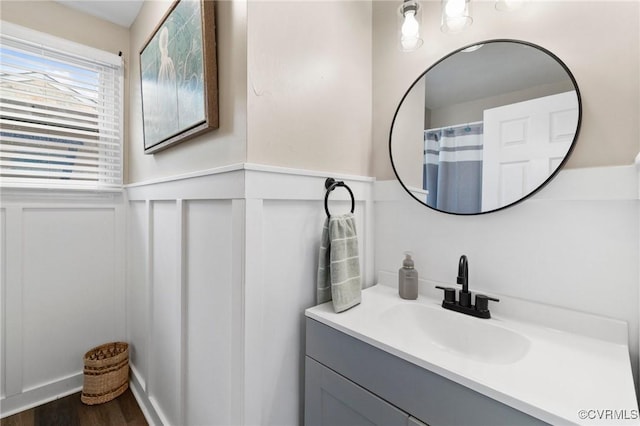204 Prince Albert Ave, Colonial Heights, VA 23834 - bathroom featuring vanity, a wainscoted wall, wood finished floors, and a decorative wall
