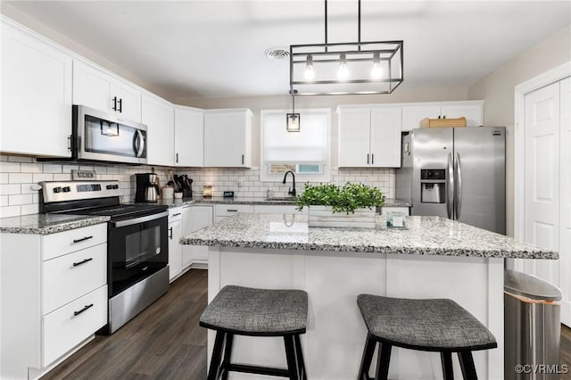 204 Prince Albert Ave, Colonial Heights, VA 23834 - kitchen with appliances with stainless steel finishes, dark wood-style flooring, tasteful backsplash, and white cabinets