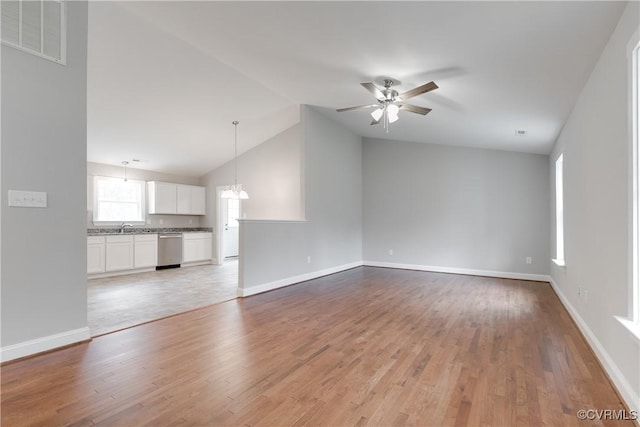 68 Halls Store Rd, Mineral, VA 23117 - unfurnished living room with vaulted ceiling, a ceiling fan, light wood-type flooring, and a chandelier