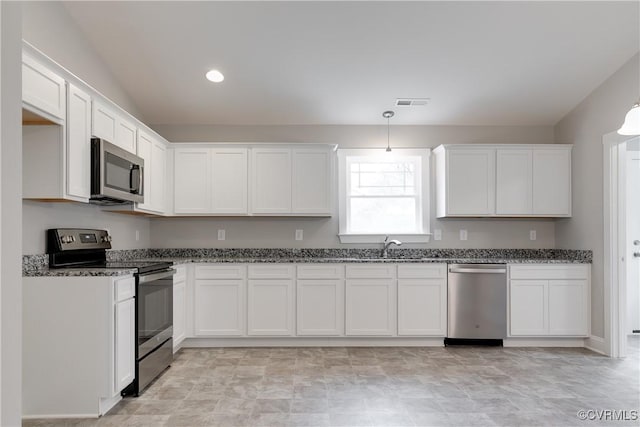 68 Halls Store Rd, Mineral, VA 23117 - kitchen featuring appliances with stainless steel finishes, dark stone countertops, white cabinetry, and recessed lighting