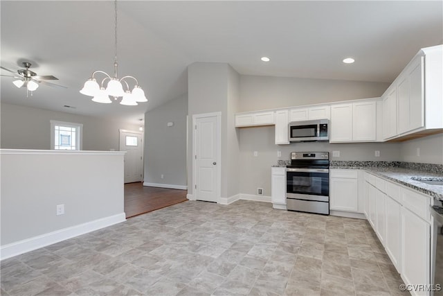 68 Halls Store Rd, Mineral, VA 23117 - kitchen featuring appliances with stainless steel finishes, lofted ceiling, light stone counters, white cabinetry, and a chandelier