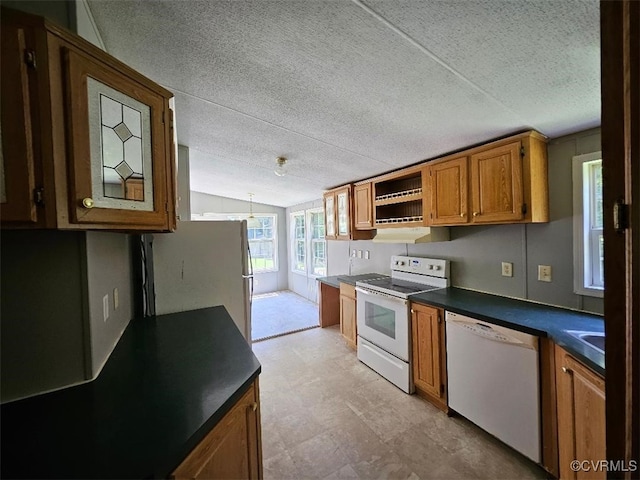 467 Oakland Rd, Farnham, VA 22460 - kitchen with white appliances, lofted ceiling, brown cabinets, dark countertops, and a textured ceiling
