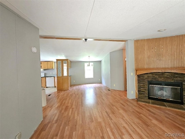 467 Oakland Rd, Farnham, VA 22460 - unfurnished living room with light wood-style floors, a fireplace, and a textured ceiling