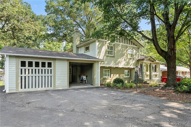 6482 Robin Way, Mechanicsville, VA 23111 - split level home featuring a chimney, asphalt driveway, and a garage