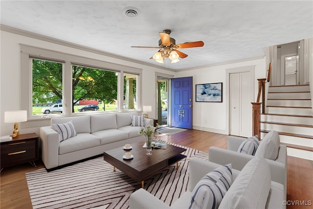 6482 Robin Way, Mechanicsville, VA 23111 - living area with plenty of natural light, wood finished floors, a ceiling fan, stairs, and crown molding