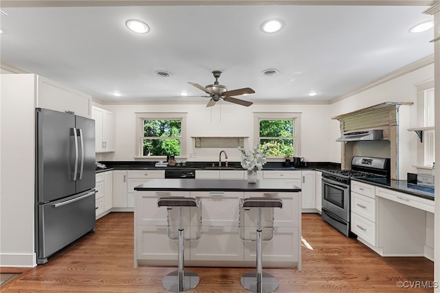 6482 Robin Way, Mechanicsville, VA 23111 - kitchen featuring stainless steel appliances, plenty of natural light, crown molding, dark countertops, and under cabinet range hood
