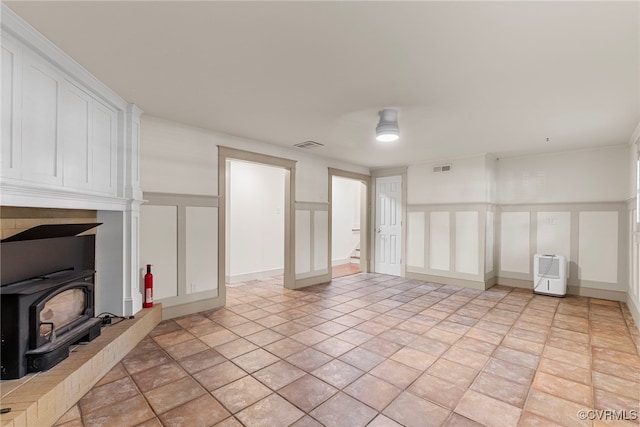 6482 Robin Way, Mechanicsville, VA 23111 - unfurnished living room featuring a decorative wall and a wood stove