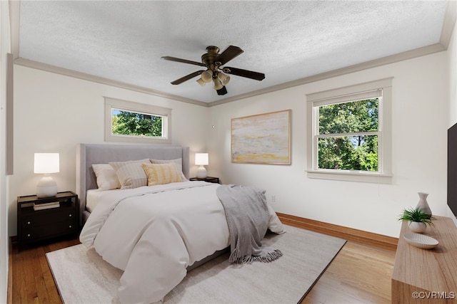 6482 Robin Way, Mechanicsville, VA 23111 - bedroom with multiple windows, wood finished floors, a textured ceiling, and a ceiling fan