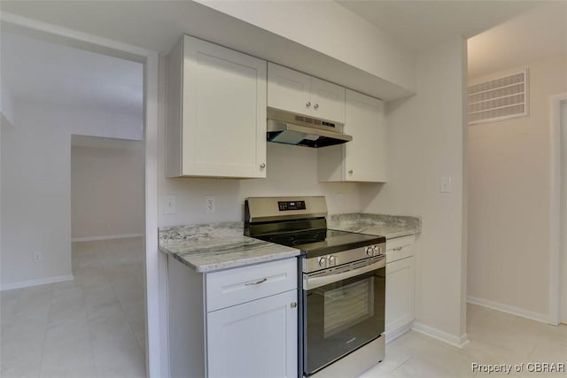 164 Lake One Dr, Hampton, VA 23666 - kitchen with stainless steel range with electric stovetop, under cabinet range hood, white cabinets, light stone counters, and light tile patterned floors