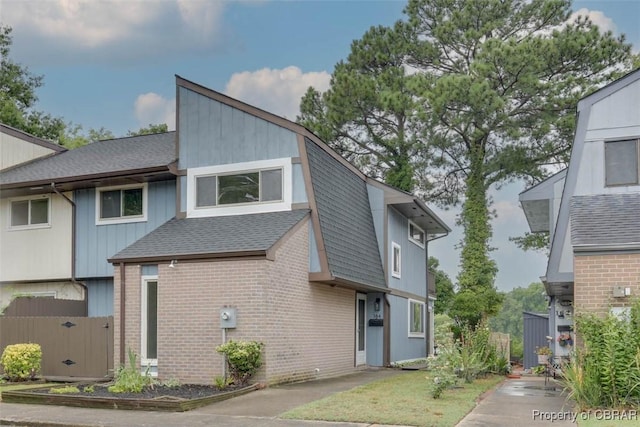 164 Lake One Dr, Hampton, VA 23666 - view of home's exterior with a shingled roof and brick siding