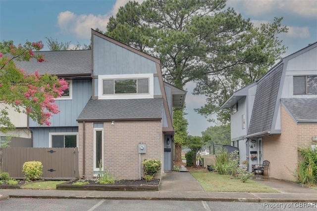 164 Lake One Dr, Hampton, VA 23666 - mid-century inspired home with a shingled roof, brick siding, a gate, and board and batten siding