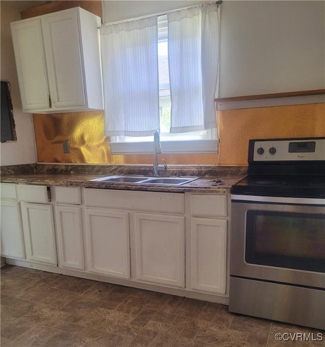 1227 Hilton Pl, Petersburg, VA 23803 - kitchen featuring stainless steel electric stove, dark countertops, and white cabinetry