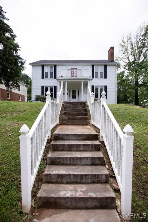 405 E 2nd St, Farmville, VA 23901 - view of front of house featuring a chimney, a front yard, a balcony, and stairs
