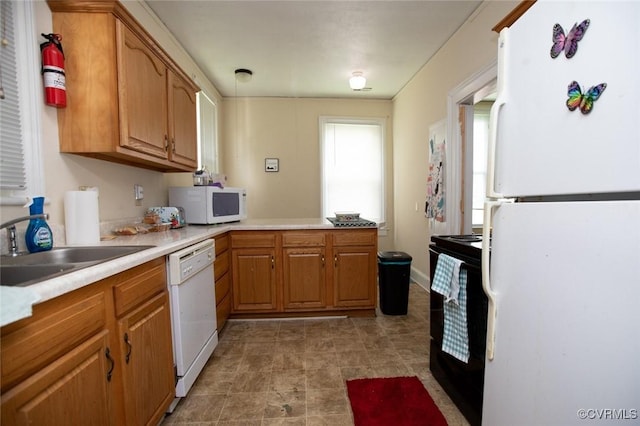 405 E 2nd St, Farmville, VA 23901 - kitchen with white appliances, a peninsula, light countertops, and brown cabinets
