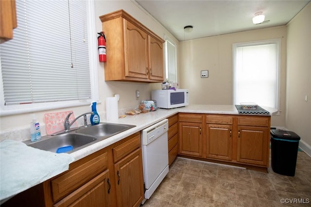 405 E 2nd St, Farmville, VA 23901 - kitchen featuring white appliances, light countertops, a peninsula, and brown cabinetry