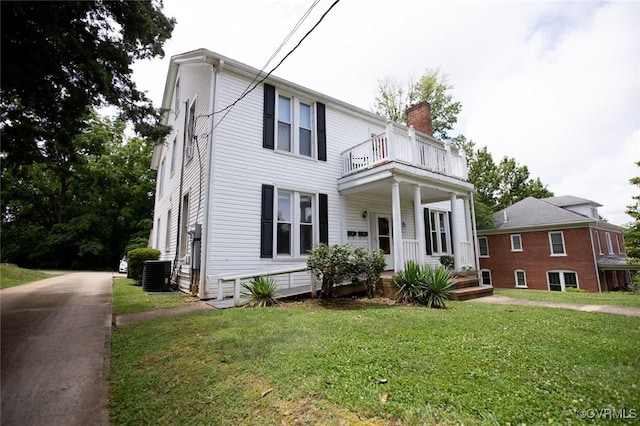 405 E 2nd St, Farmville, VA 23901 - view of front of home with a balcony, covered porch, a front yard, and a chimney