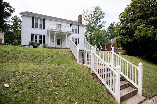 405 E 2nd St, Farmville, VA 23901 - colonial-style house with a chimney, a front lawn, and a balcony