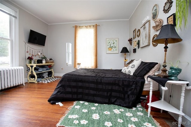 405 E 2nd St, Farmville, VA 23901 - bedroom with radiator, wood finished floors, and ornamental molding