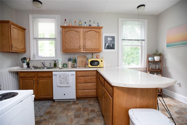 405 E 2nd St, Farmville, VA 23901 - kitchen featuring white appliances, a peninsula, light countertops, stone finish flooring, and a kitchen bar