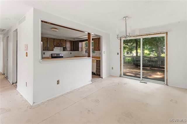 9502 Timber Pass, Glen Allen, VA 23060 - kitchen with concrete floors, stainless steel range with electric cooktop, refrigerator, a chandelier, and light countertops