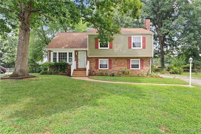 6437 Moon Ln, Chesterfield, VA 23234 - tri-level home with a chimney, a front lawn, and brick siding