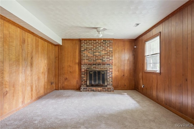 6437 Moon Ln, Chesterfield, VA 23234 - unfurnished living room featuring ceiling fan, carpet floors, a brick fireplace, wooden walls, and ornamental molding