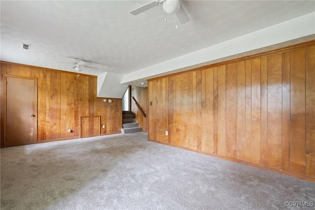 6437 Moon Ln, Chesterfield, VA 23234 - unfurnished living room featuring wood walls, a ceiling fan, stairs, and carpet flooring
