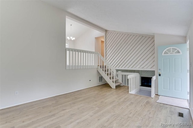 7 Cathy Dr, Newport News, VA 23608 - unfurnished living room with lofted ceiling, wood finished floors, a chandelier, and a large fireplace