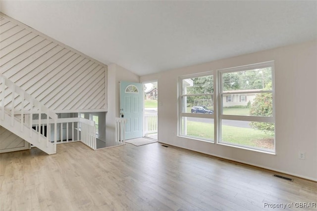 7 Cathy Dr, Newport News, VA 23608 - unfurnished living room featuring wood finished floors, plenty of natural light, and vaulted ceiling