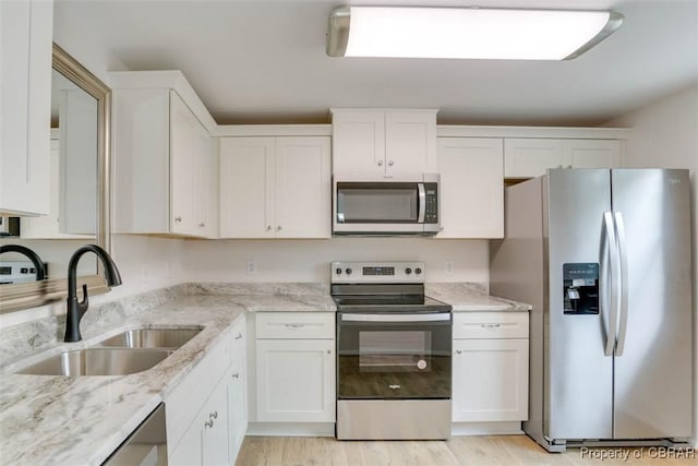 7 Cathy Dr, Newport News, VA 23608 - kitchen with stainless steel appliances, white cabinetry, light wood finished floors, and light stone counters