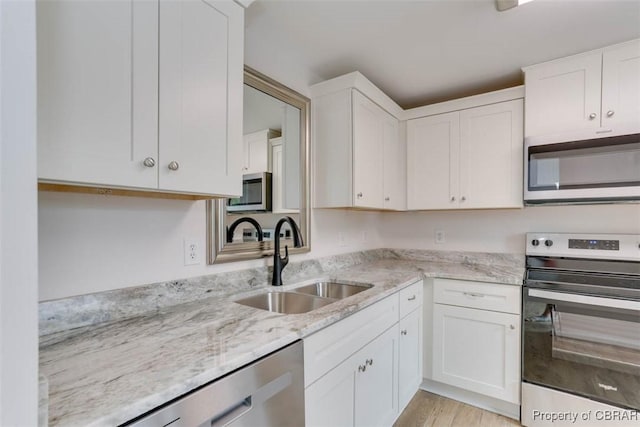 7 Cathy Dr, Newport News, VA 23608 - kitchen with stainless steel appliances, white cabinetry, light stone countertops, and light wood-style floors