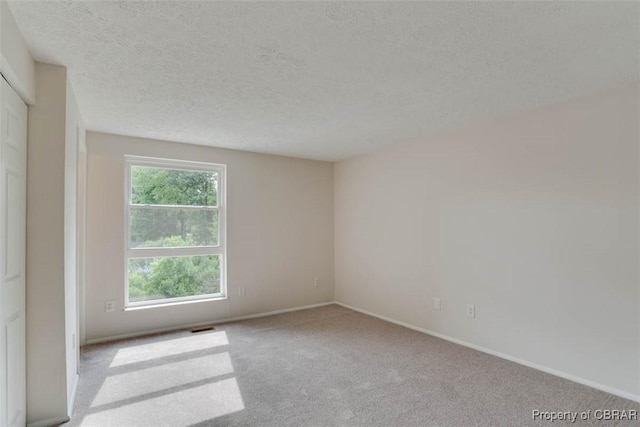 7 Cathy Dr, Newport News, VA 23608 - empty room with a textured ceiling and carpet floors