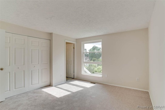 7 Cathy Dr, Newport News, VA 23608 - unfurnished bedroom with carpet flooring, a textured ceiling, and a closet