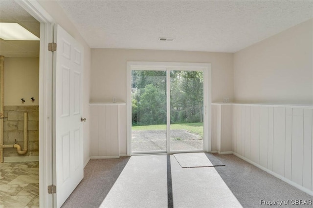 7 Cathy Dr, Newport News, VA 23608 - entryway with a wainscoted wall, a textured ceiling, and carpet